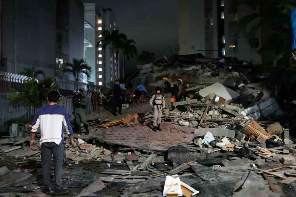 People walk amid debris after an earthquake in Caracas, Venezuela, Wednesday, June 24, 2026. (AP Photo/Ariana Cubillos)