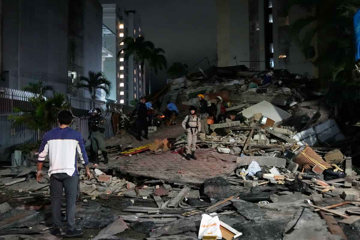 People walk amid debris after an earthquake in Caracas, Venezuela, Wednesday, June 24, 2026. (AP Photo/Ariana Cubillos)